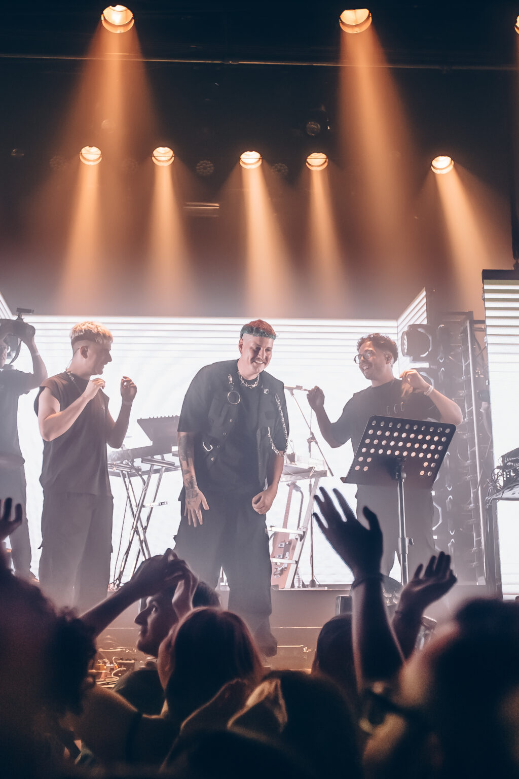 The full ensemble on stage in warm orange light — Evlay at Niceto Club, Buenos Aires, 19 December 2023. Photographed by Anita Almaraz.