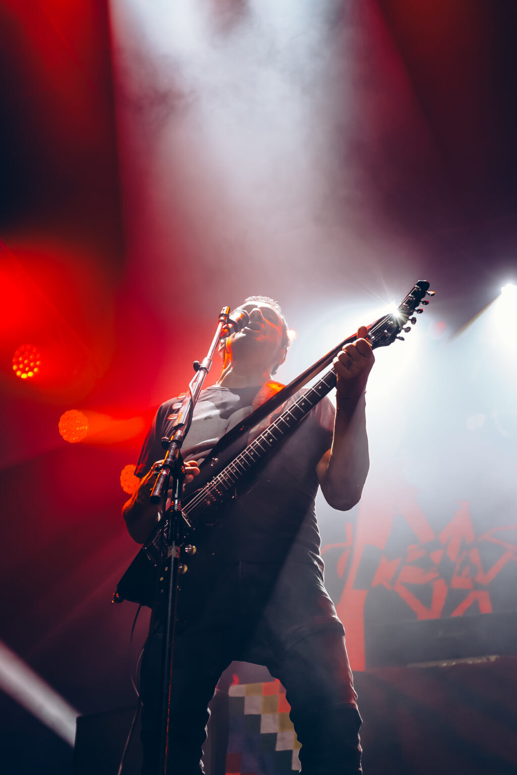 Guitarist lit from below in red — Divididos at Estadio Obras Sanitarias, Buenos Aires, 19 January 2024. Photographed by Anita Almaraz.