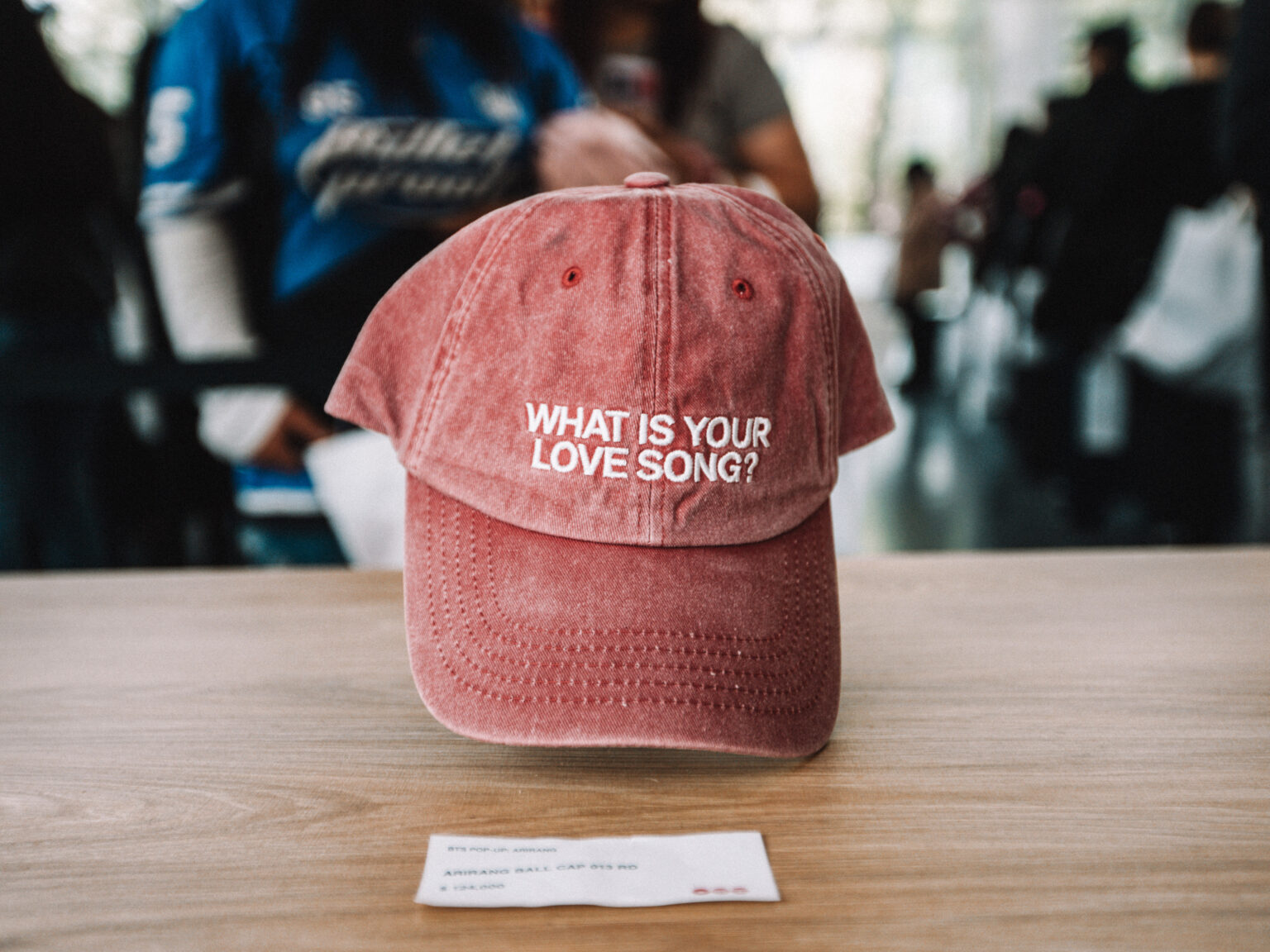 Embroidered cap on display at the merchandise stand at the BTS POP-UP: ARIRANG IN BUENOS AIRES, Centro de Convenciones Dr. Arturo Frondizi, Vicente Lopez, 2026 — photographed by Anita Almaraz for K-HipHop Argentina
