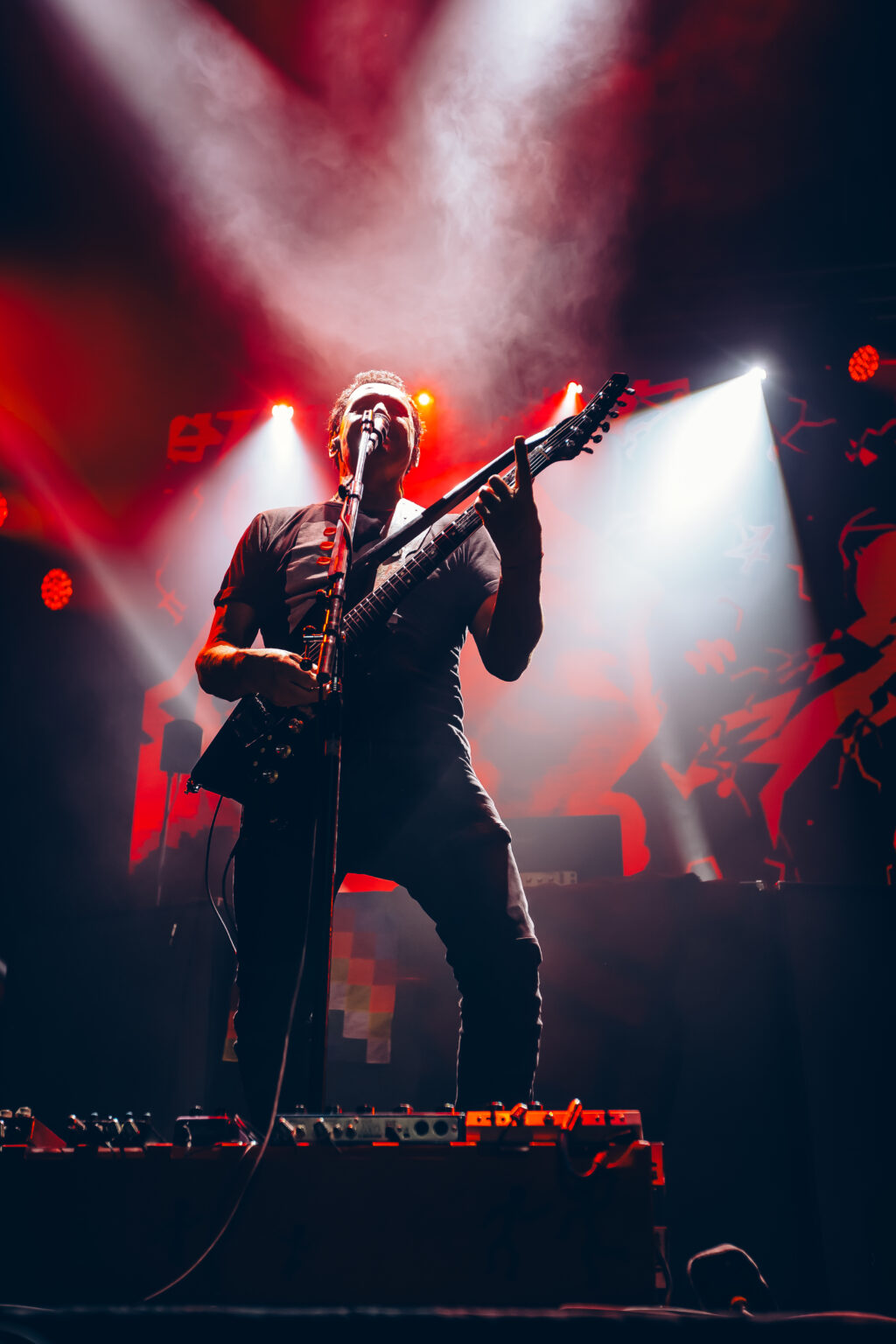 Guitarist in the smoke with the lights behind him — Divididos at Estadio Obras Sanitarias, Buenos Aires, 19 January 2024. Photographed by Anita Almaraz.
