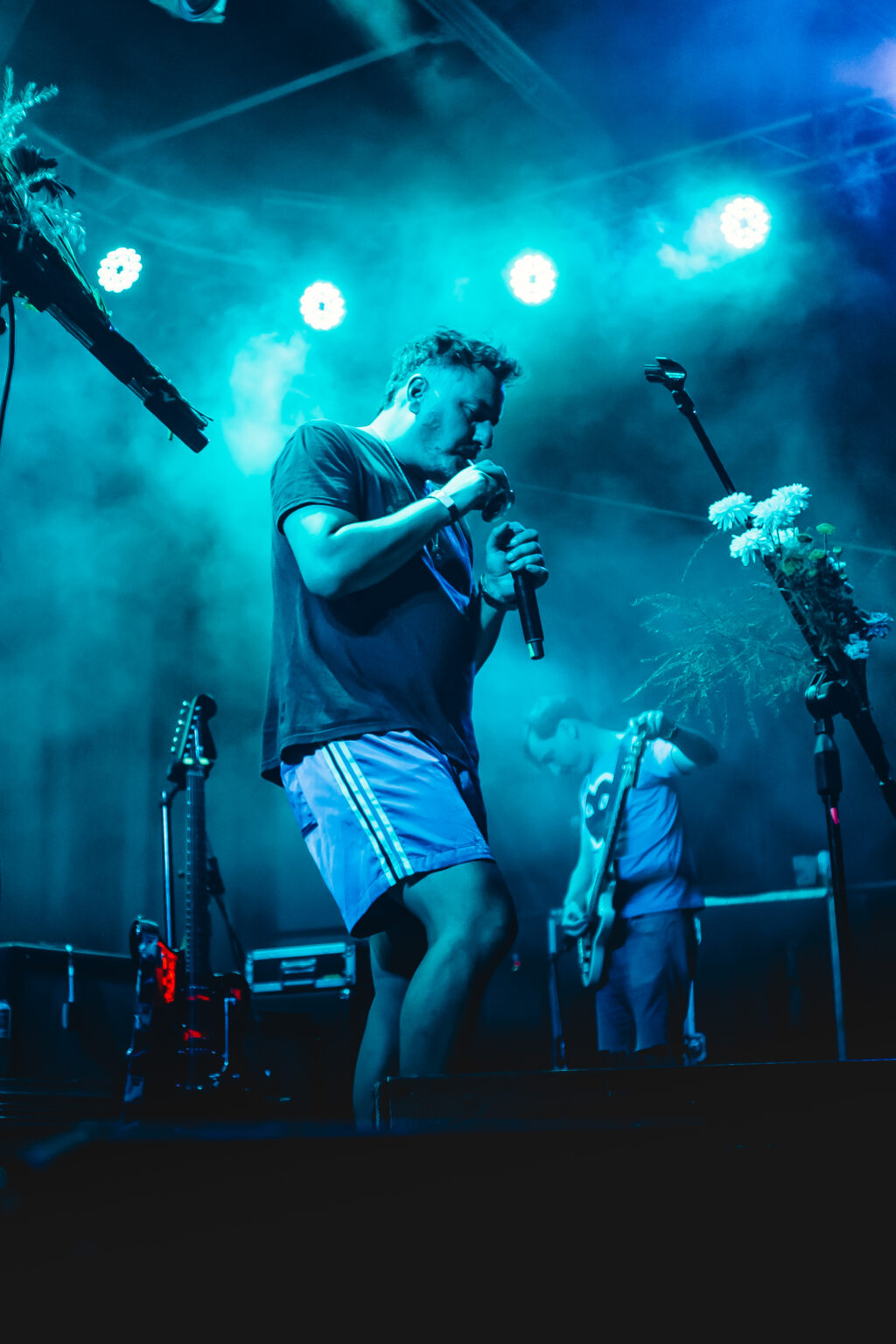 A singer leaning into the microphone through blue smoke &mdash; FestiLaptra at Ciudad Cultural Konex, Buenos Aires, 17 February 2024. Photographed by Anita Almaraz.