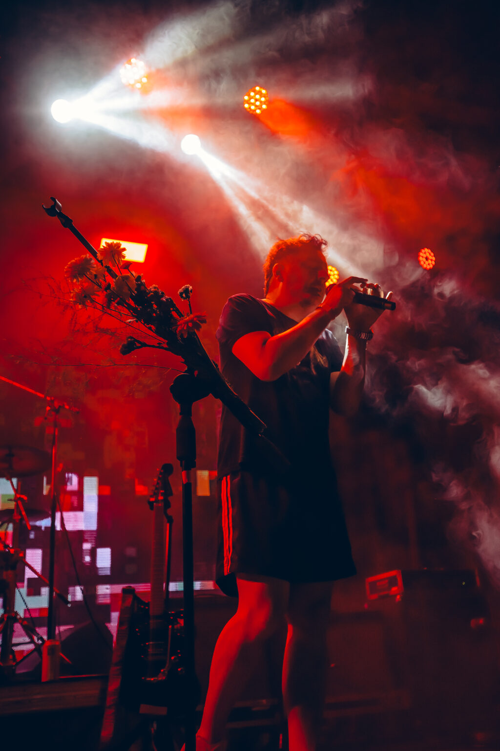 A singer with his head thrown back under red lights &mdash; FestiLaptra at Ciudad Cultural Konex, Buenos Aires, 17 February 2024. Photographed by Anita Almaraz.
