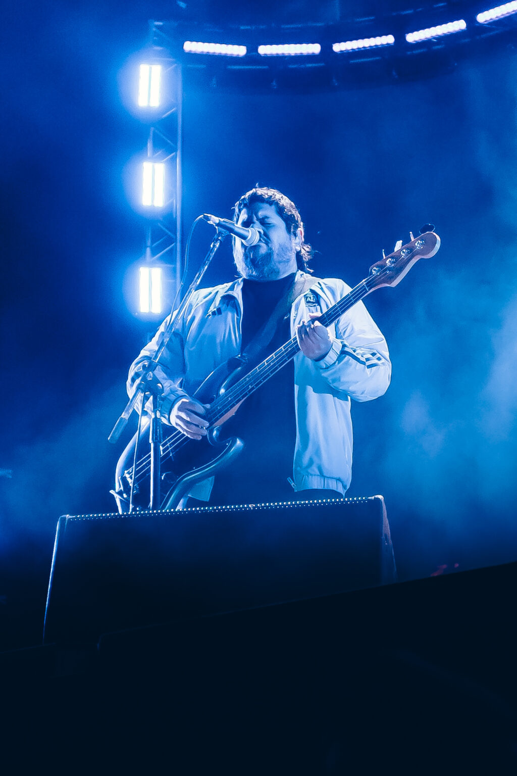 Guitarist of the band under blue light — Festival Buena Vibra, Ciudad Universitaria, Buenos Aires, 2024. Photographed by Anita Almaraz.