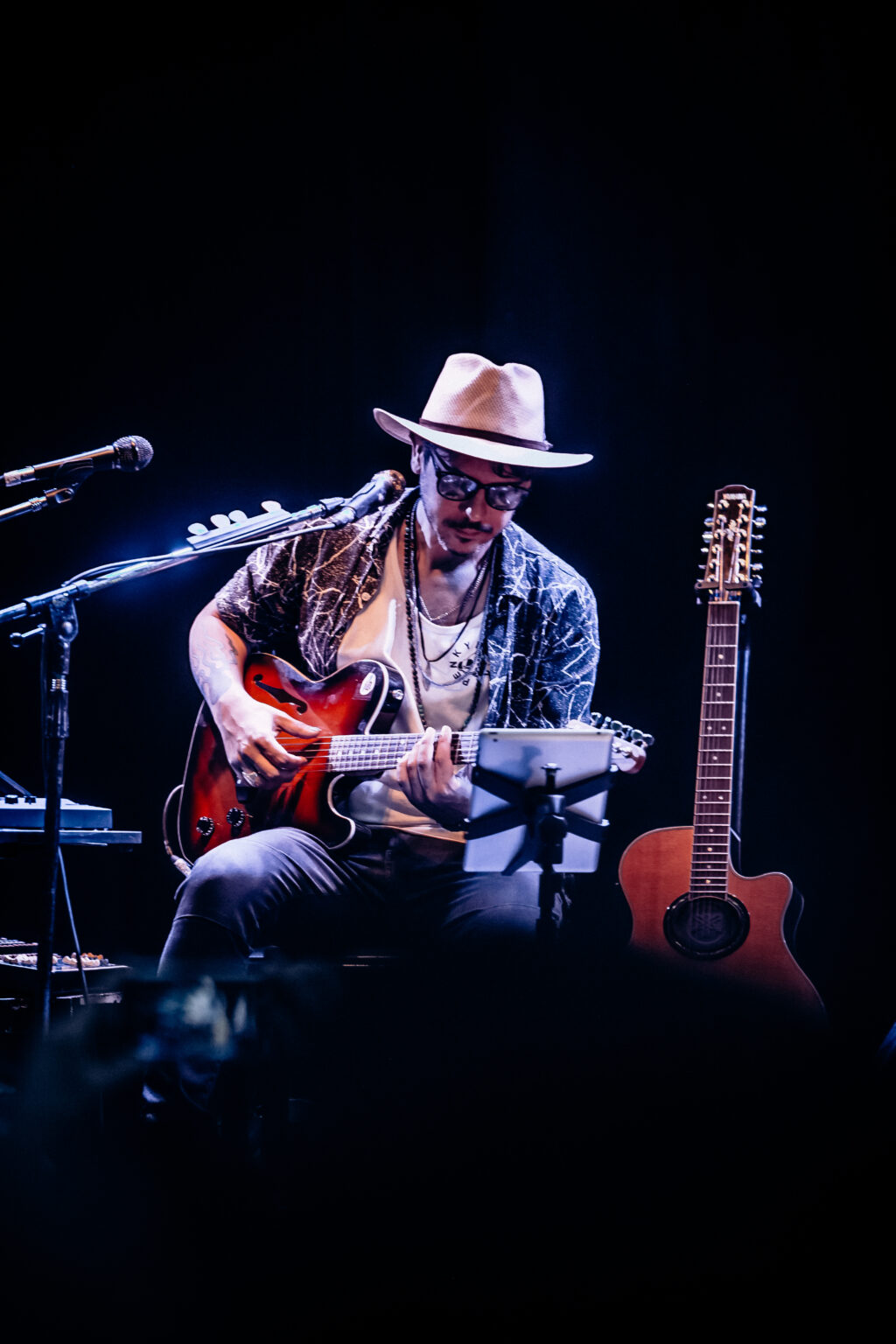 The artist with his guitar beside the instrument rack — Lisandro Aristimuño at Ciudad Cultural Konex, Buenos Aires, 11 December 2021. Photographed by Anita Almaraz.