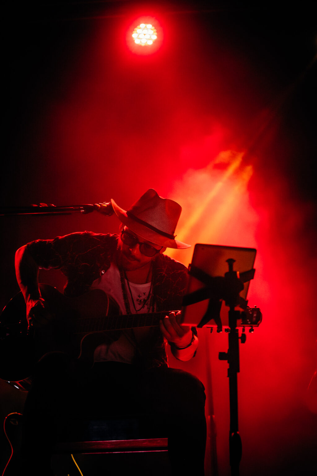 The artist in silhouette against red light — Lisandro Aristimuño at Ciudad Cultural Konex, Buenos Aires, 11 December 2021. Photographed by Anita Almaraz.