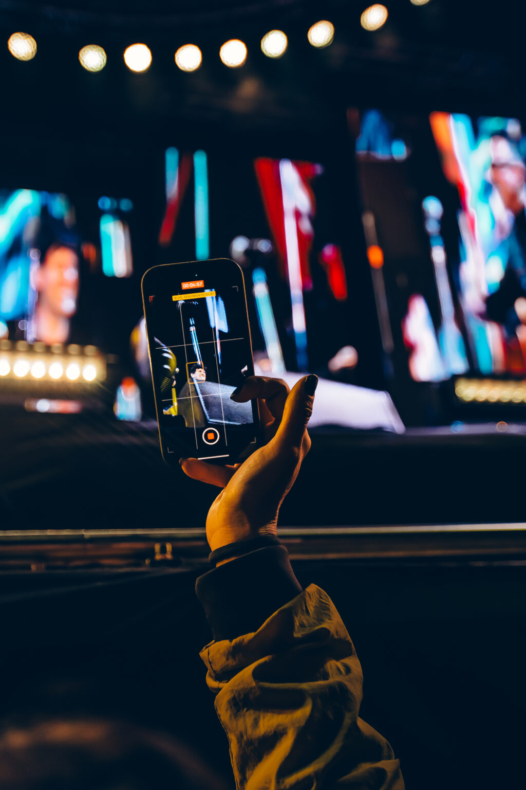 A phone held up with the show on its screen — Ciro y los Persas at Estadio José Amalfitani, Vélez Sarsfield, Buenos Aires, 9 September 2023. Photographed by Anita Almaraz.