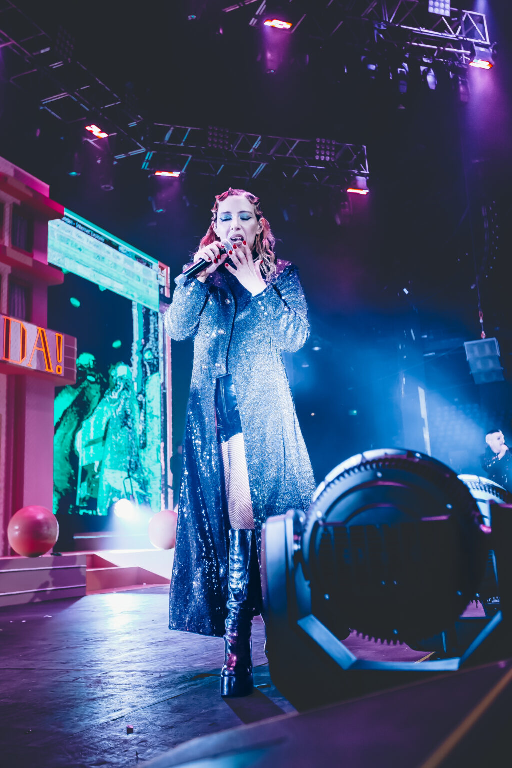 Singer on stage under green light — Hotel Miranda! at Luna Park, Buenos Aires, 6 October 2023. Photographed by Anita Almaraz.