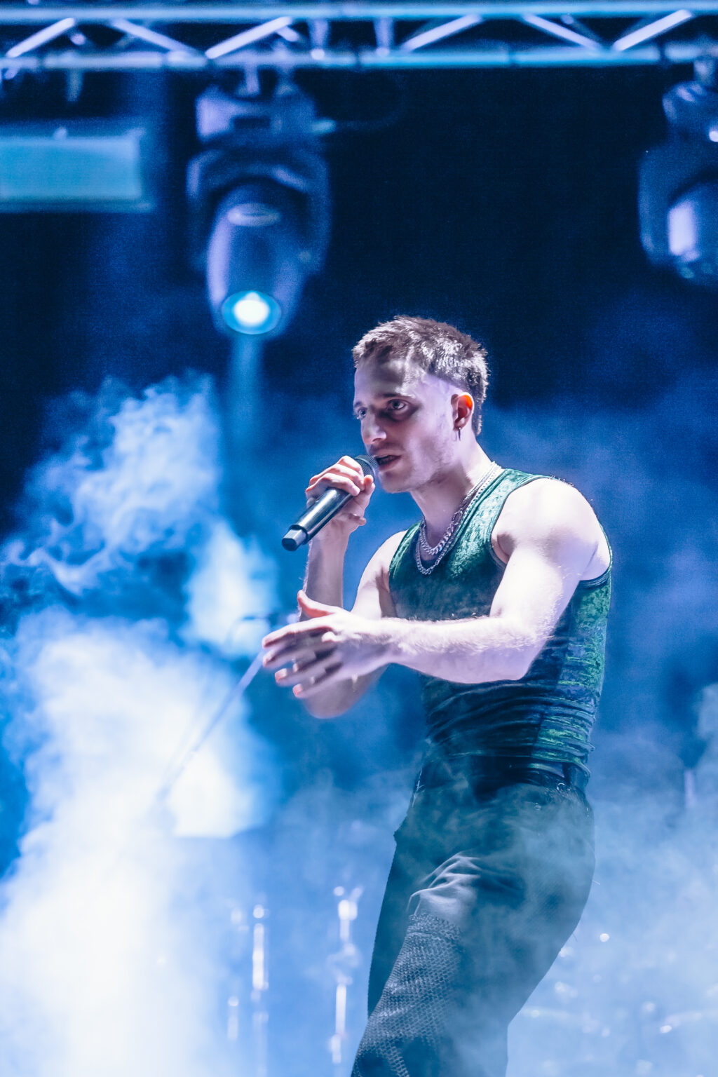 Wos singing through the stage smoke — Wos live in Buenos Aires, photographed by Anita Almaraz.