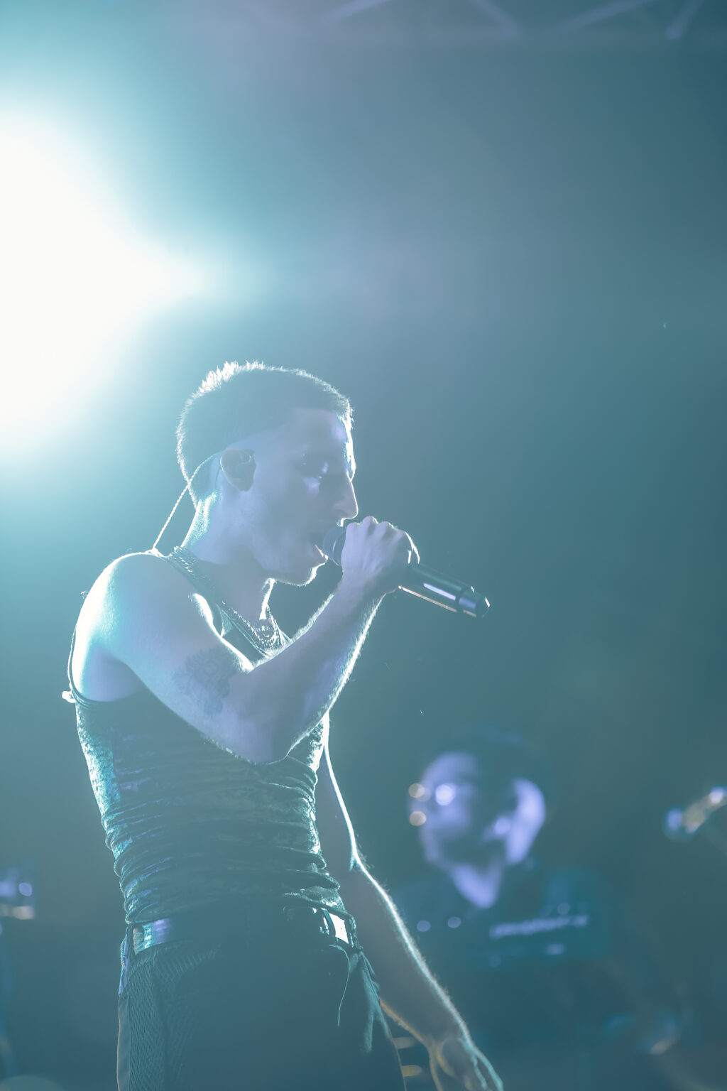 Wos singing in a blown-out white light — Wos live in Buenos Aires, photographed by Anita Almaraz.