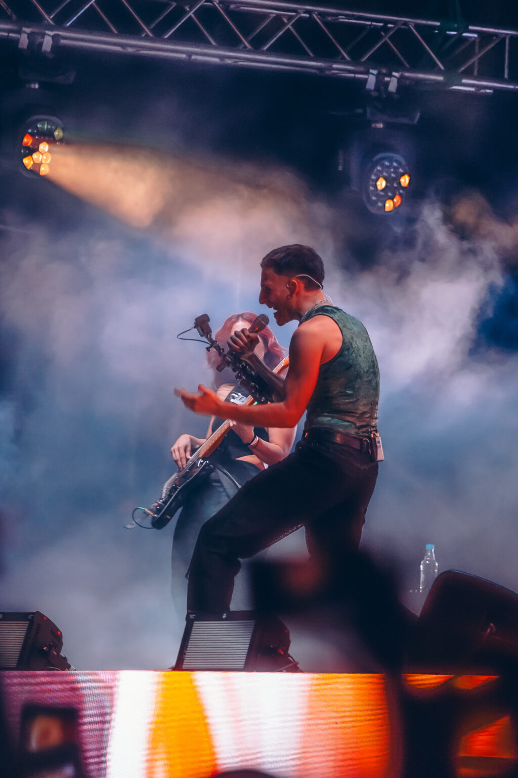 Wos on stage in the smoke and warm light — Wos live in Buenos Aires, photographed by Anita Almaraz.
