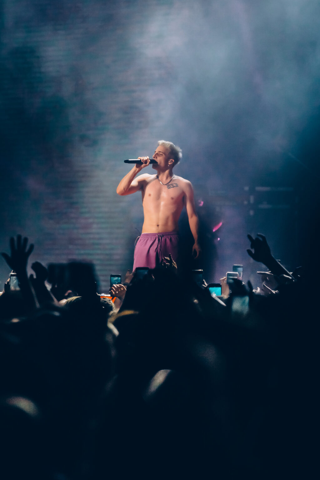 Wos leaning over the crowd during a show — Wos live in Buenos Aires, photographed by Anita Almaraz.