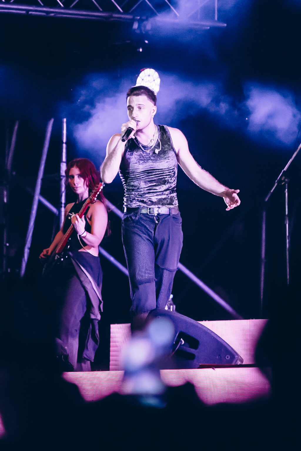 Wos and his dancers under blue and violet light — Wos live in Buenos Aires, photographed by Anita Almaraz.