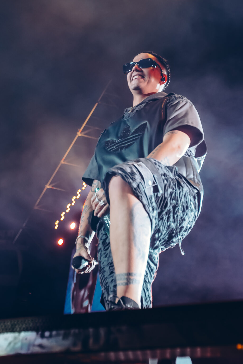 Duki crouching at the front of the stage — Duki at Estadio River Plate, Buenos Aires, 2 December 2023. Photographed by Anita Almaraz.