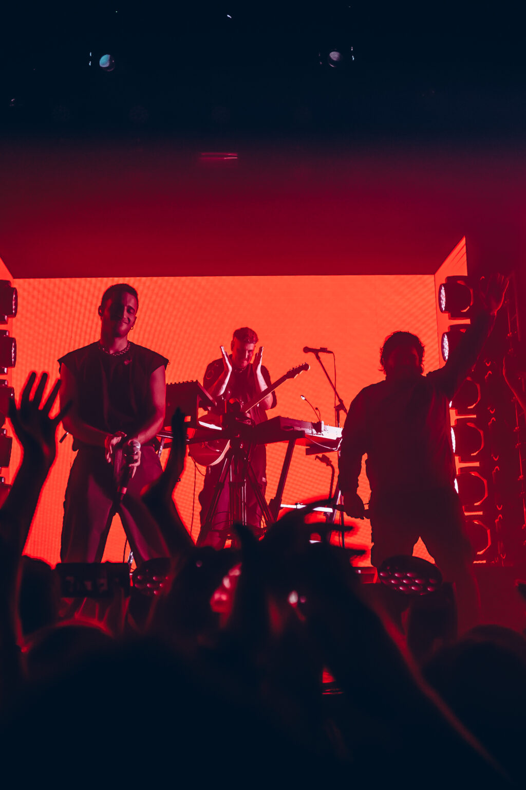 The band in silhouette against the red backdrop — Evlay at Niceto Club, Buenos Aires, 19 December 2023. Photographed by Anita Almaraz.