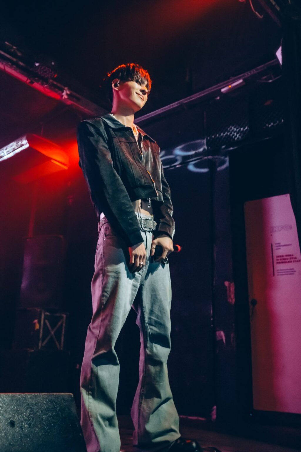 Performer in a dark jacket against the pink lights — Way Better at Club Cultural Matienzo, Buenos Aires, 2026. Photographed by Anita Almaraz.
