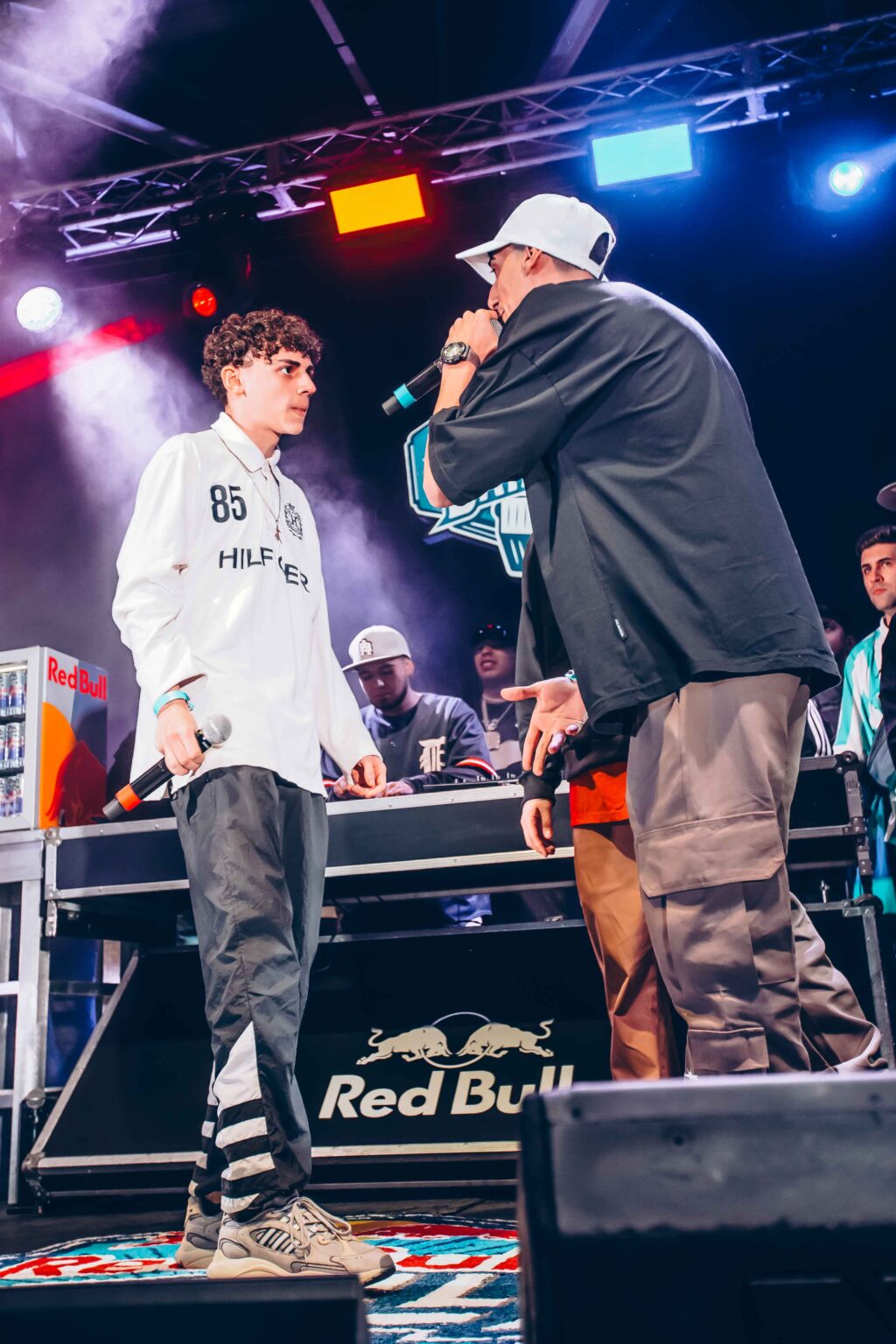 MC in a cap with the host behind him — Red Bull Batalla, Final Nacional Argentina 2024, 1 June 2024. Photographed by Anita Almaraz.