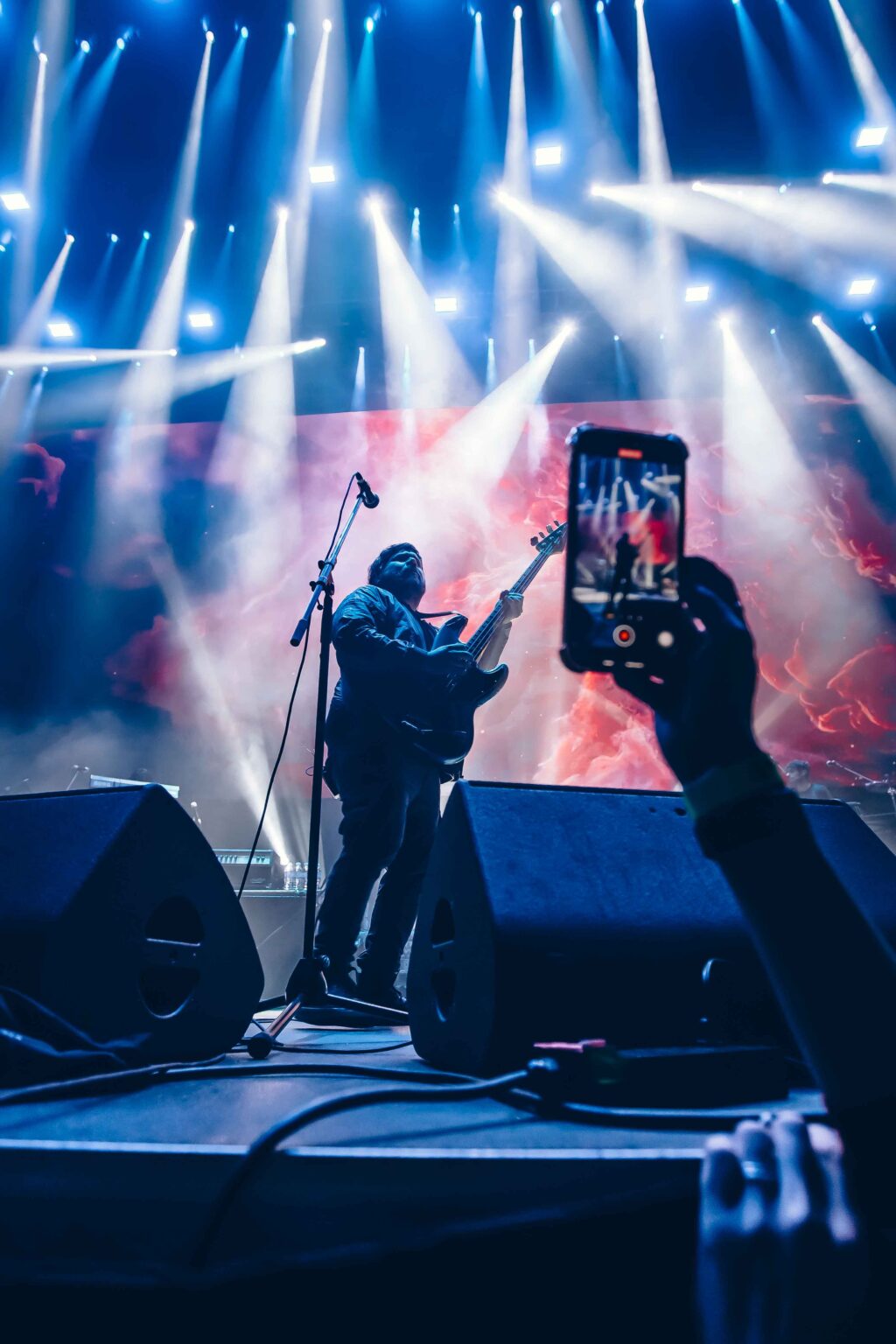 A phone filming the stage from the crowd — El Mató a un Policía Motorizado at Movistar Arena, Buenos Aires, 16 June 2024. Photographed by Anita Almaraz.