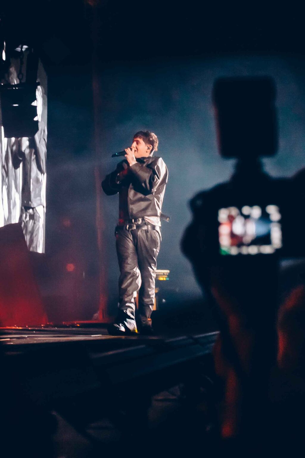 A camera operator filming Dillom from the side of the stage — Dillom at Estadio Luna Park, Buenos Aires, 19 June 2024. Photographed by Anita Almaraz.