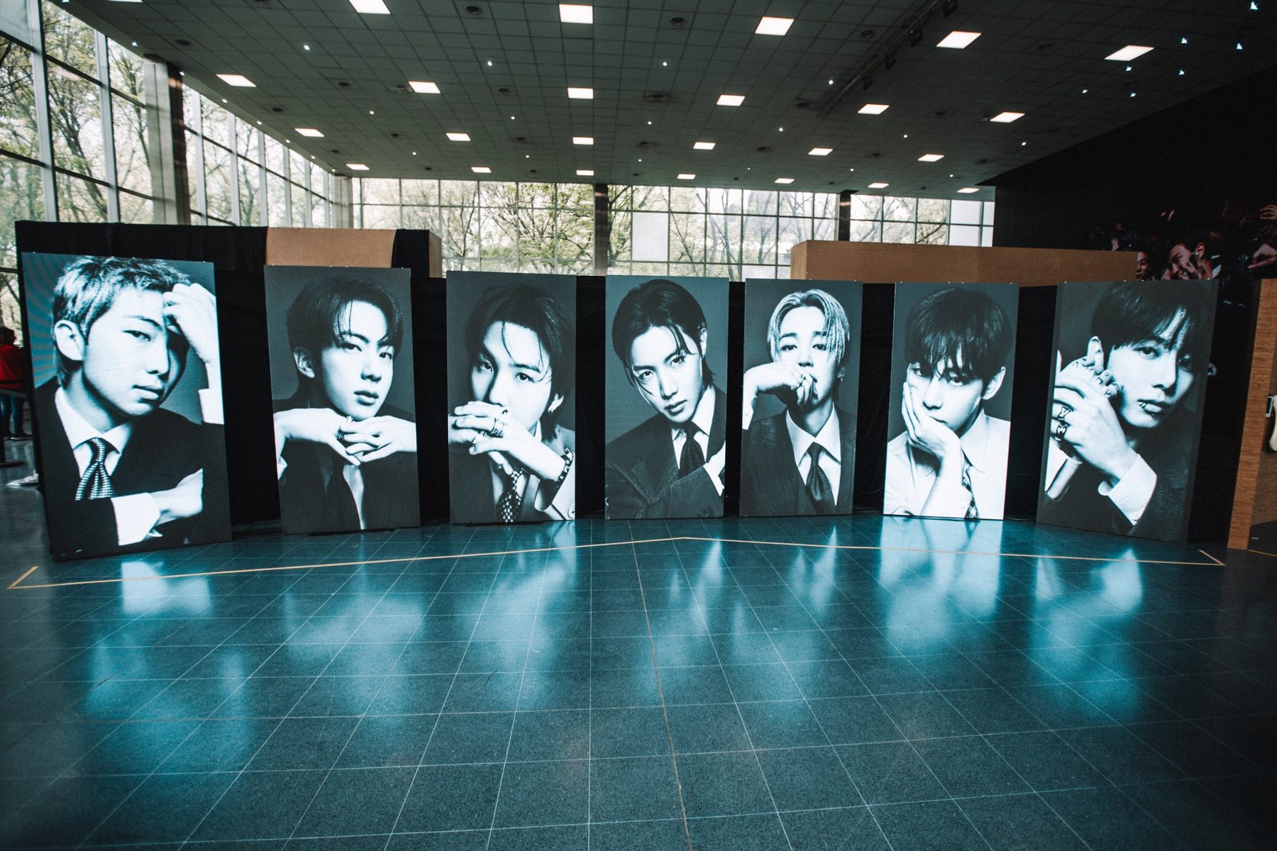 Seven BTS member portrait panels at the BTS POP-UP: ARIRANG IN BUENOS AIRES, Vicente Lopez, 2026 — photographed by Anita Almaraz for K-HipHop Argentina